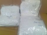 two bags of white towels sitting on top of a cardboard box