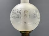 a glass lamp that has a picture of a man and a woman on it