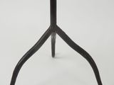 a close up of a black metal table with a white background