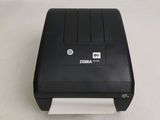 an image of a black printer sitting on top of a white surface