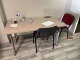 a table with two chairs and a bottle of water on it