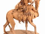 statue of a man riding a camel with a woman on it
