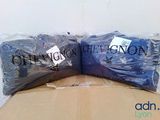 two bags of blue shirts sitting on top of a cardboard box
