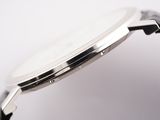 a close up of a watch on a white surface