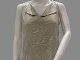 female mannequin wearing a tan top and black pants