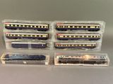 four train cars that are lined up on the table