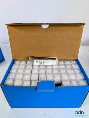 une boîte bleue remplie d'un grand nombre de cigarettes et d'une télécommande