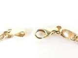 a close up of a gold bracelet with a chain on a white background