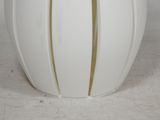 a white vase with a gold stripe on it
