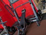 a gym room with a red wall and a black and white gym equipment