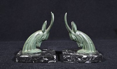 pair of antique bronze fish bookends on marble base