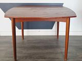 a small table with a wooden top on a hard wood floor