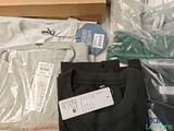 a lot of clothes that are sitting on a table
