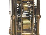 a gold clock that is sitting on a table