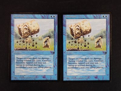 two cards that are on a black table
