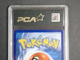a pokemon card in a plastic case on a table