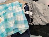 a pile of clothing on a shelf in a store