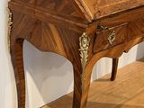a small wooden desk with a drawer on top of it