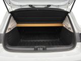 the trunk of a white car with a wooden bench in the trunk