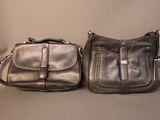 pair of black leather purses sitting next to each other on a table