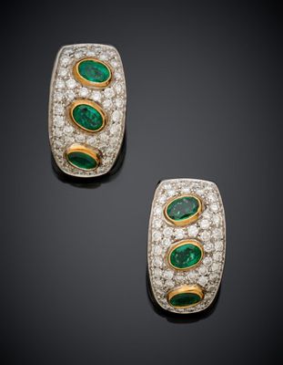 a pair of emerald and diamond earrings