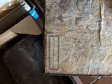 an old book sitting on top of a pile of boxes