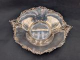 a silver plate with a cross on it on a black background