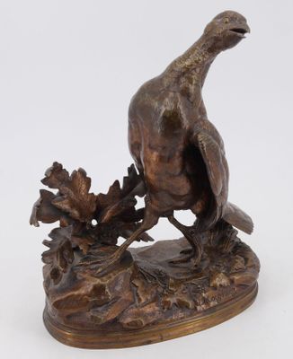 an image of a bronze statue of a pheasant on a rock
