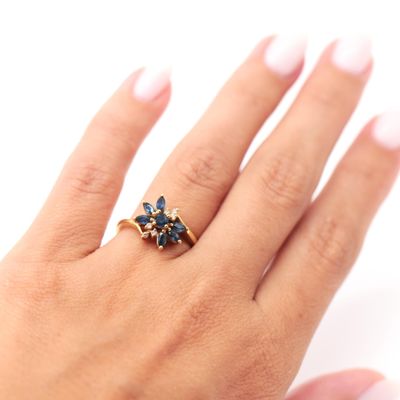a woman ' s hand with a ring on it