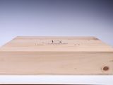 an empty wooden box sitting on top of a table next to a pair of scissors