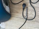 an image of a vacuum on the floor with a cord connected to it