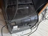 a black computer sitting on top of a desk next to a tv