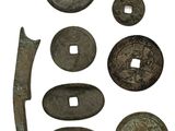 an image of a group of ancient coins and a knife