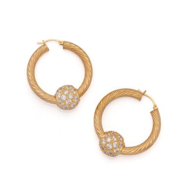 a pair of gold and diamond hoop earrings
