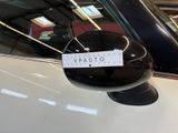 a sticker on the side mirror of a white car