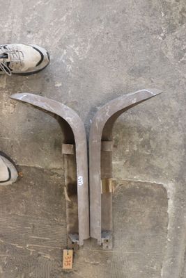 a person standing next to a pair of shoes on the ground