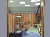 a mirror that is sitting on the wall in the room