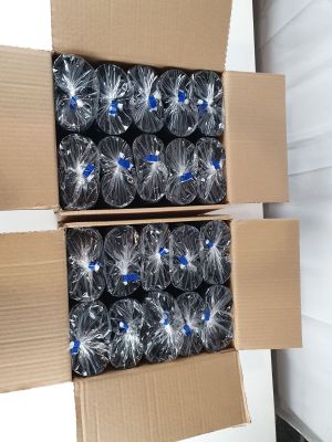 two cardboard boxes filled with bottles of water sitting on top of a floor