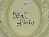 a white plate with writing on it with a black marker on it