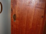 a close up of a wooden door with a key in it