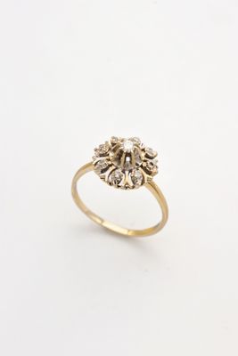 a close up of a gold ring on a white background