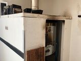 an image of a kitchen with a stove in the corner