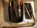 many different tools in a container on the floor