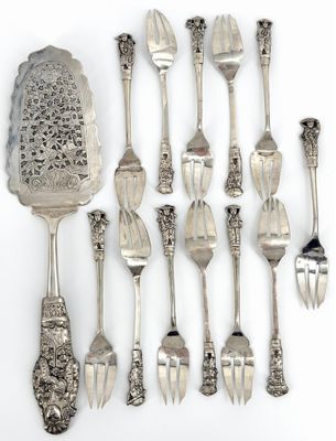a lot of silver spoons and forks on the table
