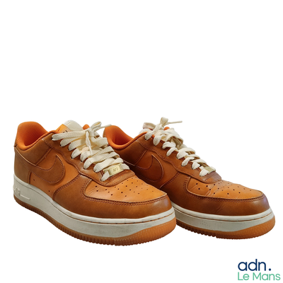 a pair of shoes that are on a white surface