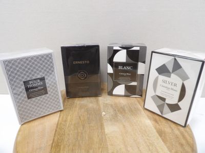three boxes of perfume sitting on top of a table next to each other