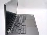 a laptop that is open on a white surface
