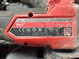 a close up of a red and black tool on the ground