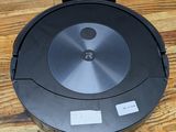 an image of a robotic vacuum cleaner sitting on a wooden table