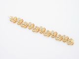an image of a gold bracelet on a white background